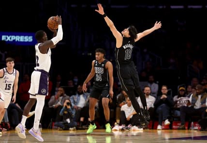 Nov 13, 2022; Los Angeles, California, USA;  Brooklyn Nets forward Yuta Watanabe (18) defends against Los Angeles Lakers guard Kendrick Nunn (12) during the first quarter at Crypto.com Arena. Mandatory Credit: Kiyoshi Mio-USA TODAY Sports