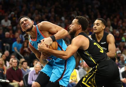 Nov 16, 2022; Phoenix, Arizona, USA; Phoenix Suns guard Devin Booker (1) battles for the ball against Golden State Warriors guard Stephen Curry (30) in the first half at Footprint Center. Mandatory Credit: Mark J. Rebilas-USA TODAY Sports