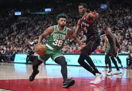 Dec 5, 2022; Toronto, Ontario, CAN; Boston Celtics guard Marcus Smart (36) drives to the net against Toronto Raptors forward Christian Koloko (35) during the first half at Scotiabank Arena. Mandatory Credit: John E. Sokolowski-USA TODAY Sports