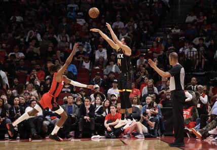 zDec 13, 2022; Houston, Texas, USA; Phoenix Suns guard Landry Shamet (14) makes a three point basket against Houston Rockets guard Jalen Green (4) in the second half at Toyota Center. Mandatory Credit: Thomas Shea-USA TODAY Sports