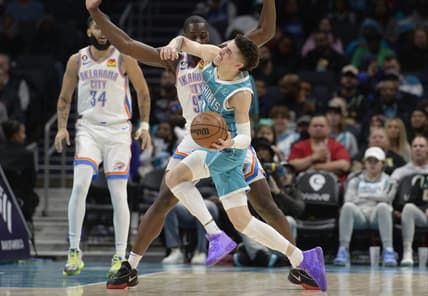 Dec 29, 2022; Charlotte, North Carolina, USA; Charlotte Hornets guard LaMelo Ball (1) is fouled by Oklahoma City Thunder forward Eugene Omoruyi (2) during the first half at the Spectrum Center. Mandatory Credit: Sam Sharpe-USA TODAY Sports