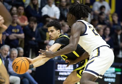 Jan 18, 2023; Berkeley, California, USA; Oregon Ducks guard Will Richardson (0) passes around California Golden Bears forward Sam Alajiki (24) during the first half at Haas Pavilion. Mandatory Credit: D. Ross Cameron-USA TODAY Sports