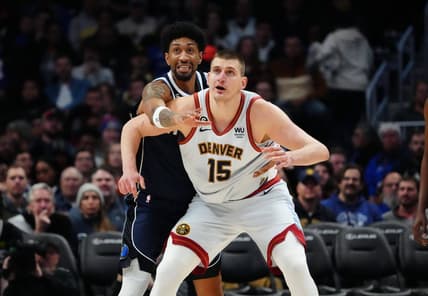 Feb 15, 2023; Denver, Colorado, USA; Dallas Mavericks forward Christian Wood (35) reaches over Denver Nuggets center Nikola Jokic (15) in the second half at Ball Arena. Mandatory Credit: Ron Chenoy-USA TODAY Sports