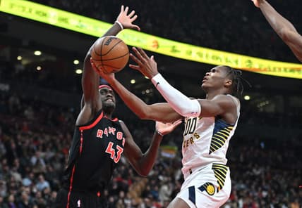 Mar 22, 2023; Toronto, Ontario, CAN;  Indiana Pacers forward Bennedict Mathurin (00) shoots the ball as Toronto Raptors forward Pascal Siakam (43) defends in the first half at Scotiabank Arena. Mandatory Credit: Dan Hamilton-USA TODAY Sports