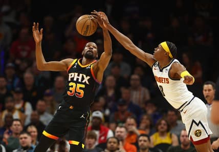 Apr 6, 2023; Phoenix, Arizona, USA; Phoenix Suns forward Kevin Durant (35) grabs a loose ball against Denver Nuggets forward Peyton Watson (8) in the first half at Footprint Center. Mandatory Credit: Mark J. Rebilas-USA TODAY Sports