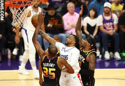 Apr 18, 2023; Phoenix, Arizona, USA; Los Angeles Clippers guard Norman Powell (center) drives to the basket against Phoenix Suns forward Kevin Durant (35) and Torrey Craig in the second half during game two of the 2023 NBA playoffs at Footprint Center. Mandatory Credit: Mark J. Rebilas-USA TODAY Sports