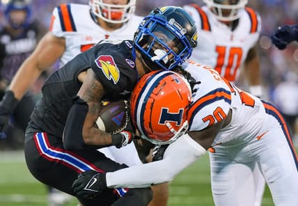 Sep 8, 2023; Lawrence, Kansas, USA; Kansas Jayhawks wide receiver Quentin Skinner (0) is tackled by Illinois Fighting Illini defensive back Tyler Strain (20) during the first half at David Booth Kansas Memorial Stadium. Mandatory Credit: Jay Biggerstaff-USA TODAY Sports
