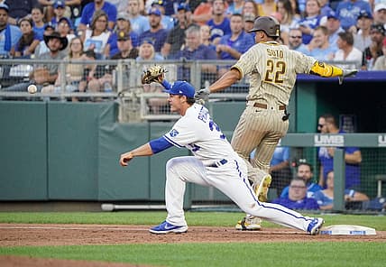 Aug 27, 2022; Kansas City, Missouri, USA; Kansas City Royals first baseman Nick Pratto (32) bobbles a throw to first base as San Diego Padres right fielder Juan Soto (22) reaches safely in the third inning at Kauffman Stadium. Mandatory Credit: Denny Medley-USA TODAY Sports