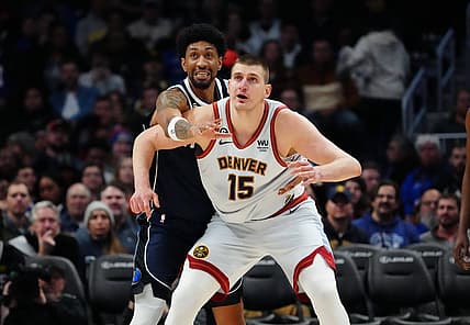 Feb 15, 2023; Denver, Colorado, USA; Dallas Mavericks forward Christian Wood (35) reaches over Denver Nuggets center Nikola Jokic (15) in the second half at Ball Arena. Mandatory Credit: Ron Chenoy-USA TODAY Sports