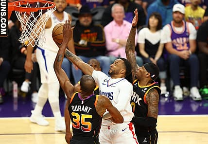 Apr 18, 2023; Phoenix, Arizona, USA; Los Angeles Clippers guard Norman Powell (center) drives to the basket against Phoenix Suns forward Kevin Durant (35) and Torrey Craig in the second half during game two of the 2023 NBA playoffs at Footprint Center. Mandatory Credit: Mark J. Rebilas-USA TODAY Sports