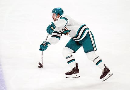 Dec 15, 2023; Tempe, Arizona, USA; San Jose Sharks defenseman Kyle Burroughs (4) passes the puck against the Arizona Coyotes during the third period at Mullett Arena. Mandatory Credit: Joe Camporeale-USA TODAY Sports