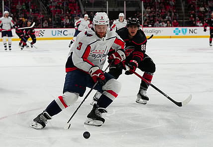 Dec 17, 2023; Raleigh, North Carolina, USA;  Washington Capitals defenseman Nick Jensen (3) skates with the puck past Carolina Hurricanes left wing Teuvo Teravainen (86) during the first period at PNC Arena. Mandatory Credit: James Guillory-USA TODAY Sports