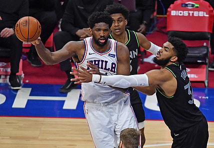 Apr 3, 2021; Philadelphia, Pennsylvania, USA; Philadelphia 76ers center Joel Embiid (left) passes the ball against Minnesota Timberwolves center Karl-Anthony Towns (32) during the fourth quarter at Wells Fargo Center. Mandatory Credit: Eric Hartline-USA TODAY Sports