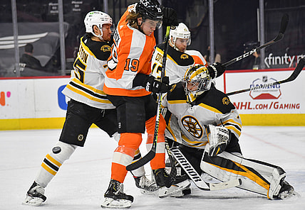 Apr 6, 2021; Philadelphia, Pennsylvania, USA; Boston Bruins defenseman Connor Clifton (75) holds back Philadelphia Flyers center Nolan Patrick (19) in front of  goaltender Jeremy Swayman (1) during the first period at Wells Fargo Center. Mandatory Credit: Eric Hartline-USA TODAY Sports