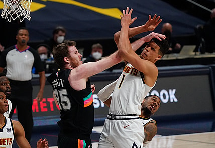 Apr 7, 2021; Denver, Colorado, USA; San Antonio Spurs center Jakob Poeltl (25) collides into Denver Nuggets forward Michael Porter Jr. (1) in the first quarter at Ball Arena. Mandatory Credit: Ron Chenoy-USA TODAY Sports