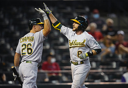 Apr 13, 2021; Phoenix, Arizona, USA; Oakland Athletics infielder Jed Lowrie (8) celebrates with teammate Matt Chapman after hitting a three run home run in the seventh inning against the Arizona Diamondbacks at Chase Field. Mandatory Credit: Mark J. Rebilas-USA TODAY Sports