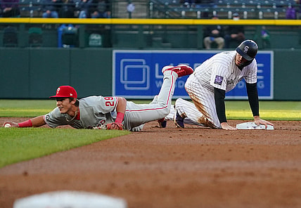 Apr 23, 2021; Denver, Colorado, USA; Philadelphia Phillies shortstop Nick Maton (29) fields the ball in front of Colorado Rockies center fielder Yonathan Daza (2) in the third inning at Coors Field. Mandatory Credit: Ron Chenoy-USA TODAY Sports