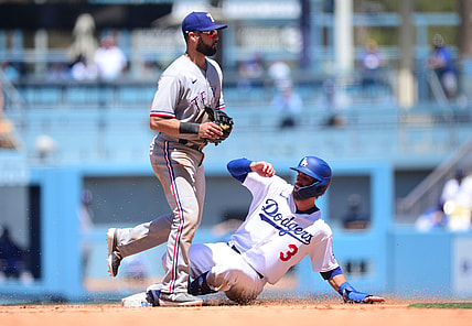 Jun 13, 2021; Los Angeles, California, USA; Los Angeles Dodgers second baseman Chris Taylor (3) reaches second against Texas Rangers shortstop Isiah Kiner-Falefa (9) during the third inning at Dodger Stadium. Mandatory Credit: Gary A. Vasquez-USA TODAY Sports