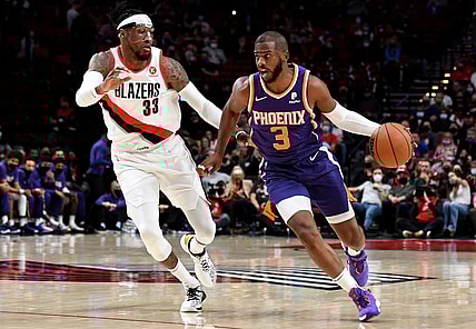 Oct 23, 2021; Portland, Oregon, USA; Phoenix Suns guard Chris Paul (3) dribbles the ball past Portland Trail Blazers forward Robert Covington (33) during the first quarter of the game at Moda Center. Mandatory Credit: Steve Dykes-USA TODAY Sports