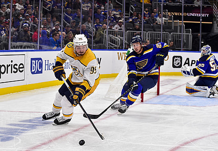 Nov 11, 2021; St. Louis, Missouri, USA;  Nashville Predators center Matt Duchene (95) handles the puck as St. Louis Blues center Tyler Bozak (21) defends during the third period at Enterprise Center. Mandatory Credit: Jeff Curry-USA TODAY Sports