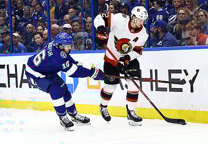 Mar 1, 2022; Tampa, Florida, USA; Ottawa Senators defenseman Thomas Chabot (72) skates with the puck as Tampa Bay Lightning right wing Taylor Raddysh (16) defends during the first period at Amalie Arena. Mandatory Credit: Kim Klement-USA TODAY Sports