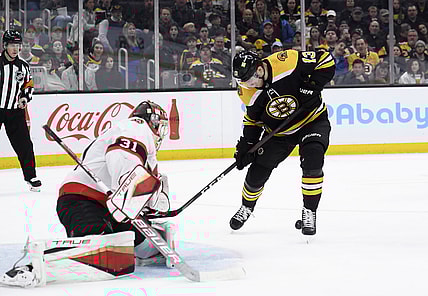Apr 14, 2022; Boston, Massachusetts, USA;  Boston Bruins center Charlie Coyle (13) tries to control a rebound in front of Ottawa Senators goaltender Anton Forsberg (31) during the first period at TD Garden. Mandatory Credit: Bob DeChiara-USA TODAY Sports