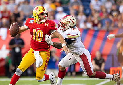 Jul 3, 2022; Canton, OH, USA; Philadelphia Stars quarterback Case Cookus (10) looks for a receiver under pressure from Birmingham Stallions inside linebacker Scooby Wright (33) during the first quarter at Tom Benson Hall of Fame Stadium. Mandatory Credit: Scott Galvin-USA TODAY Sports