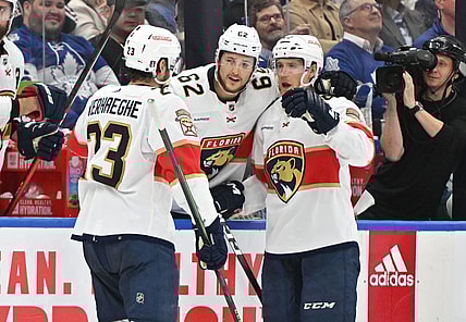 May 2, 2023; Toronto, Ontario, CANADA;   Florida Panthers forward Carter Verhaeghe (23) celebrates at the bench with defensemen Gustav Forsling (42) and Brandon Montour  (62) after scoring against the Toronto Maple Leafs in the second period in game one of the second round of the 2023 Stanley Cup Playoffs at Scotiabank Arena. Mandatory Credit: Dan Hamilton-USA TODAY Sports