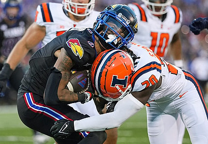 Sep 8, 2023; Lawrence, Kansas, USA; Kansas Jayhawks wide receiver Quentin Skinner (0) is tackled by Illinois Fighting Illini defensive back Tyler Strain (20) during the first half at David Booth Kansas Memorial Stadium. Mandatory Credit: Jay Biggerstaff-USA TODAY Sports