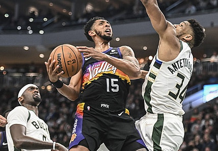 Mar 6, 2022; Milwaukee, Wisconsin, USA; Phoenix Suns guard Cameron Payne (15) looks for a shot against Milwaukee Bucks forward Giannis Antetokounmpo (34) in the second quarter at Fiserv Forum. Mandatory Credit: Benny Sieu-USA TODAY Sports