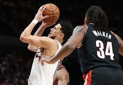 Jan 14, 2024; Portland, Oregon, USA;  Phoenix Suns guard Devin Booker (1) shoots the ball over Portland Trail Blazers forward Jabari Walker (34) in the third quarter at Moda Center. Mandatory Credit: Jaime Valdez-USA TODAY Sports