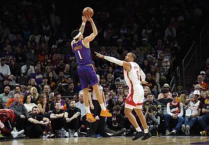 Mar 2, 2024; Phoenix, Arizona, USA; Phoenix Suns guard Devin Booker (1) shoots over Houston Rockets forward Dillon Brooks (9) during the first half at Footprint Center. Mandatory Credit: Joe Camporeale-USA TODAY Sports