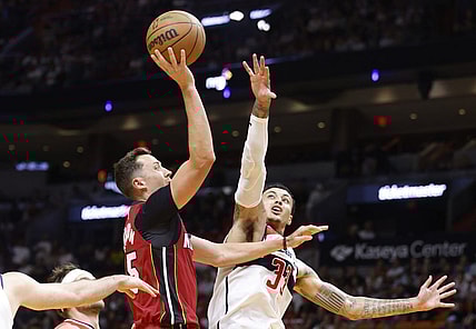 Mar 10, 2024; Miami, Florida, USA; Miami Heat forward Duncan Robinson (55) shoots over Washington Wizards forward Kyle Kuzma (33) in the first half at Kaseya Center. Mandatory Credit: Rhona Wise-USA TODAY Sports
