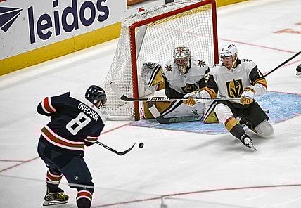 WASHINGTON, DC - NOVEMBER 01: Washington Capitals left wing Alex Ovechkin (8) fires a shot that is saved by Vegas Golden Knights defenseman Zach Whitecloud (2) and goaltender Logan Thompson (36) during the Las Vegas Golden Knights game versus the Washington Capitals on November 1, 2022 at the Capital One Arena in Washington, D.C. (Photo by Mark Goldman/Icon Sportswire)
