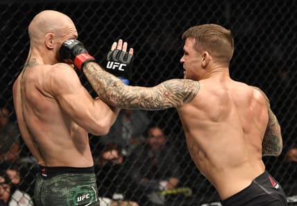 Jan 23, 2021; Abu Dhabi, United Arab Emirates; Dustin Poirier punches Conor McGregor of Ireland in a lightweight fight during the UFC 257 event inside Etihad Arena on UFC Fight Island.  Mandatory Credit: Jeff Bottari/Handout Photo via USA TODAY Sports