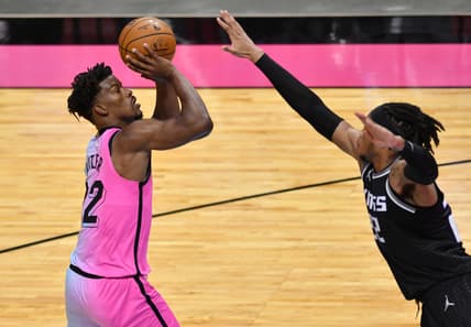 Jan 30, 2021; Miami, Florida, USA; Miami Heat forward Jimmy Butler (22) takes a shot over Sacramento Kings center Richaun Holmes (22) in the fourth quarter at American Airlines Arena. Mandatory Credit: Jim Rassol-USA TODAY Sports