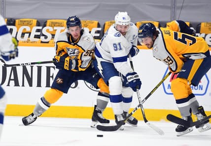 Feb 8, 2021; Nashville, Tennessee, USA; Tampa Bay Lightning center Steven Stamkos (91) works to get the puck against Nashville Predators left wing Erik Haula (56) and Nashville Predators defenseman Roman Josi (59) during the third period at Bridgestone Arena. Mandatory Credit: Christopher Hanewinckel-USA TODAY Sports