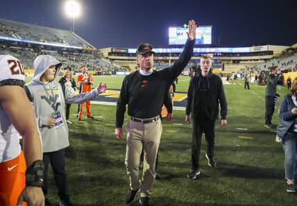 Nov 6, 2021; Morgantown, West Virginia, USA; Oklahoma State Cowboys head coach Mike Gundy waves to the crowd after defeating the West Virginia Mountaineers at Mountaineer Field at Milan Puskar Stadium. Mandatory Credit: Ben Queen-USA TODAY Sports