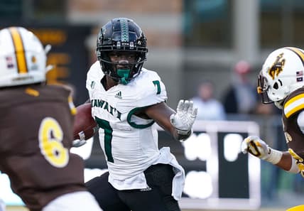 Nov 27, 2021; Laramie, Wyoming, USA; Hawaii Rainbow Warriors running back Calvin Turner Jr. (7) runs against the Wyoming Cowboys during the fourth quarter at Jonah Field at War Memorial Stadium. Mandatory Credit: Troy Babbitt-USA TODAY Sports