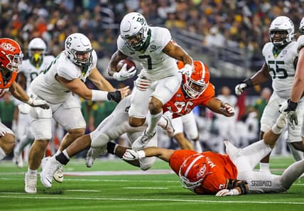 Dec 4, 2021; Arlington, TX, USA; Baylor Bears running back Abram Smith (7) hurdles Oklahoma State Cowboys defensive tackle Israel Antwine (95) during the first half of the Big 12 Conference championship game at AT&T Stadium. Mandatory Credit: Kevin Jairaj-USA TODAY Sports