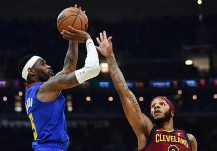 Mar 18, 2022; Cleveland, Ohio, USA;  Denver Nuggets guard Will Barton (5) shoots over the defense of Cleveland Cavaliers forward Lamar Stevens (8) during the first half at Rocket Mortgage FieldHouse. Mandatory Credit: Ken Blaze-USA TODAY Sports