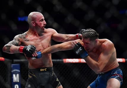 Sep 25, 2021; Las Vegas, Nevada, USA; Brian Ortega lands a hit against Alexander Volkanovski during UFC 266 at T-Mobile Arena. Mandatory Credit: Gary A. Vasquez-USA TODAY Sports