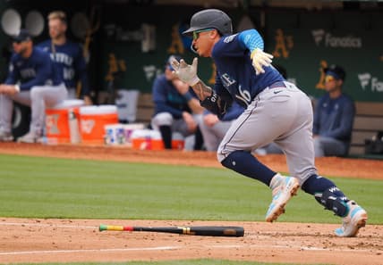 May 4, 2023; Oakland, California, USA; Seattle Mariners second baseman Kolten Wong (16) runs for first base on an RBI single against the Oakland Athletics during the fourth inning at Oakland-Alameda County Coliseum. Mandatory Credit: Kelley L Cox-USA TODAY Sports