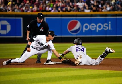 May 29, 2023; Phoenix, AZ, USA; Arizona Diamondbacks second baseman Josh Rojas (10) tags-out Colorado Rockies Ryan McMahon (24) in the second inning at Chase Field. Mandatory Credit: Rob Schumacher-Arizona Republic