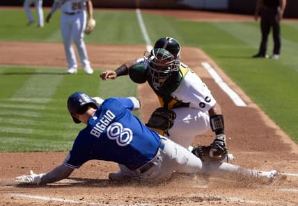 Sep 6, 2023; Oakland, California, USA; Toronto Blue Jays right fielder Cavan Biggio (8) scores a run against Oakland Athletics catcher Carlos P  rez (44) during the second inning at Oakland-Alameda County Coliseum. Mandatory Credit: D. Ross Cameron-USA TODAY Sports