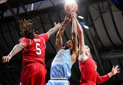 Indiana State Sycamores guard Jayson Kent (20) reaches for the ball against Utah Utes guard Deivon Smith (5) on Tuesday, April 2, 2024, during the NIT semifinals at Hinkle Fieldhouse in Indianapolis.