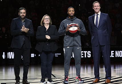 Feb 9, 2020; Portland, Oregon, USA; Portland Trail Blazers guard Damian Lillard (0) is recognized for earnng a spot in the All Star Game by Chris McGowan, president and Chief Executive Officer of Vulcan Sports and Entertainment, left, Jody Allen, chair of Portland Trail Blazers, and Portland Trail Blazers head coach Terry Stotts before Portland plays the Miami Heat at the Moda Center. Mandatory Credit: Jaime Valdez-USA TODAY Sports