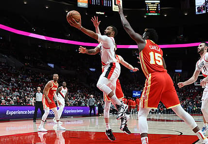 Jan 3, 2022; Portland, Oregon, USA;  Portland Trail Blazers forward Norman Powell (24) shoots under the arms of Atlanta Hawks center Clint Capela (15) in the first half at Moda Center. Mandatory Credit: Jaime Valdez-USA TODAY Sports