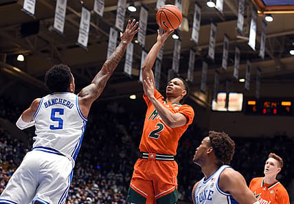Jan 8, 2022; Durham, North Carolina, USA;  Miami Hurricanes guard Isaiah Wong (2) shoots the ball over Duke Blue Devils forward Paolo Banchero (5) during the first half at Cameron Indoor Stadium. Mandatory Credit: Rob Kinnan-USA TODAY Sports
