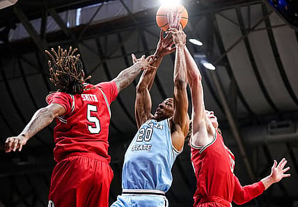 Indiana State Sycamores guard Jayson Kent (20) reaches for the ball against Utah Utes guard Deivon Smith (5) on Tuesday, April 2, 2024, during the NIT semifinals at Hinkle Fieldhouse in Indianapolis.
